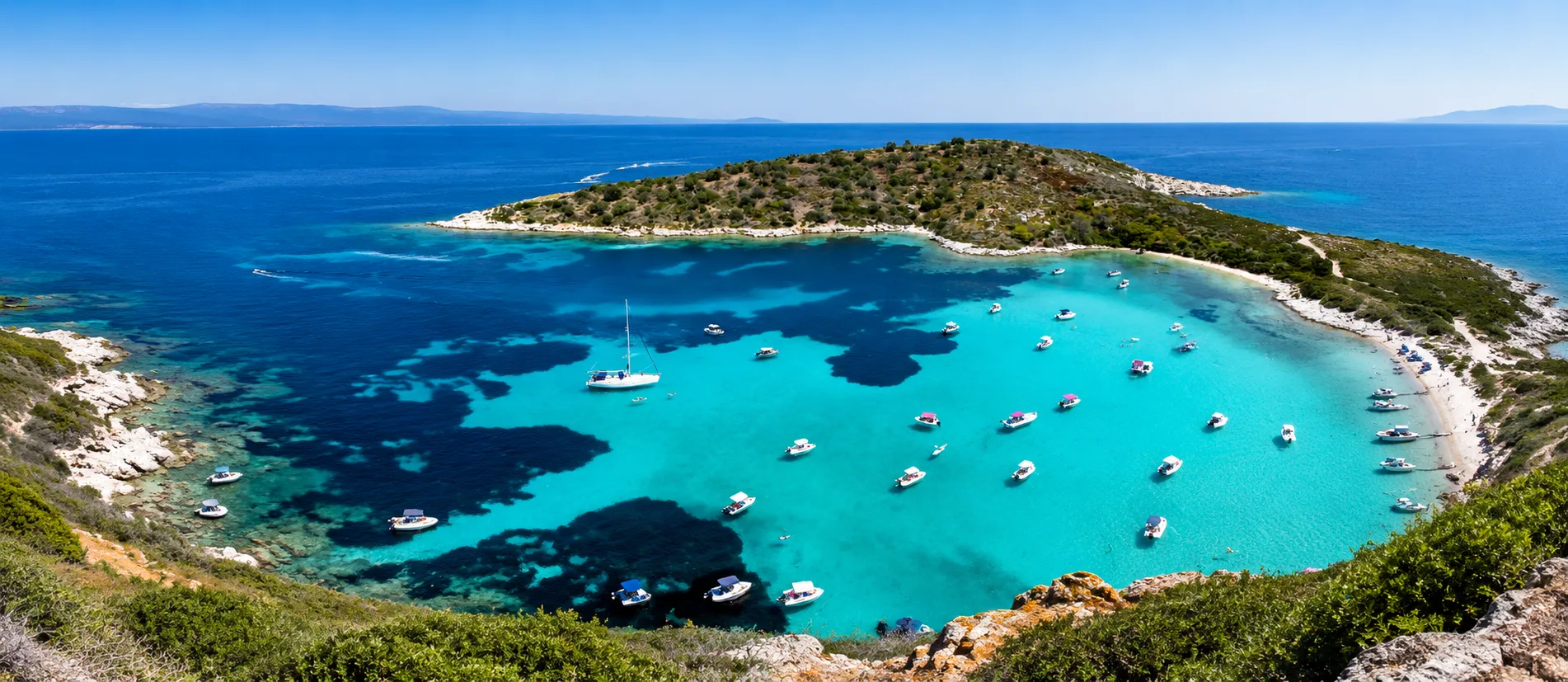 Aerial view of crystal clear waters and pine forest beach in Sithonia, Chalkidiki — near Terra Alegra Nikiti